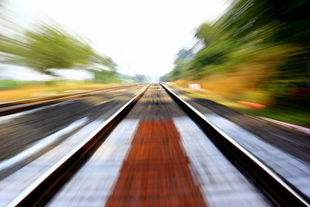 black metal train rail near trees thumbnail