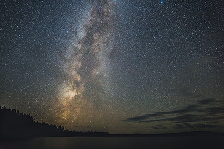 Stars in the night sky over a lake thumbnail