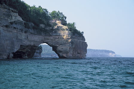 gray rock formation on body of water thumbnail