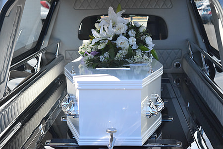 flowers over white casket thumbnail