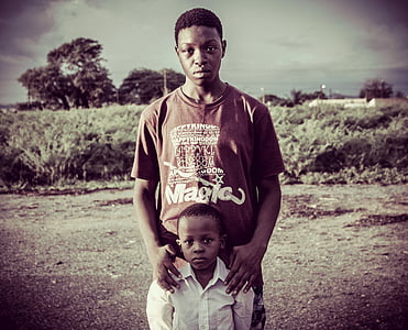 man and child standing near field thumbnail