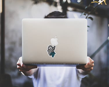 person carrying silver MacBook thumbnail