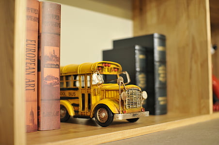 yellow school bus die-cast metal scale model on bookshelf thumbnail