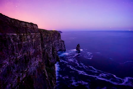 gray cliffside beside the ocean thumbnail