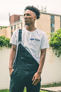man in grey crew-neck shirt and black denim dungarees thumbnail