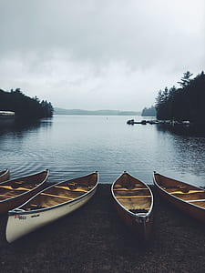 five boat beside body of water thumbnail