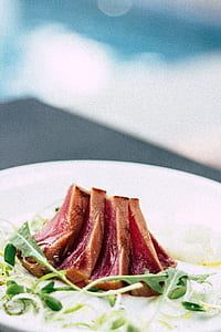 red and brown meat with vegetables dish on ceramic plate thumbnail