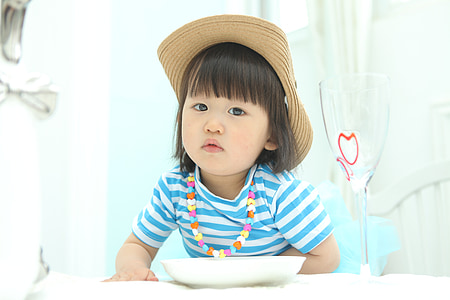 girl in front of white ceramic plate thumbnail