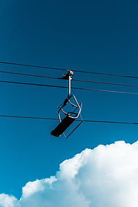 black ski lift under cloudy sky thumbnail