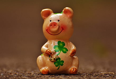 pink and green clover-print ceramic pig figurine macro photography thumbnail