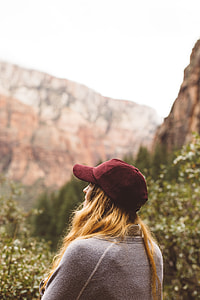 shadow depth of field photography of woman in gray top near forest thumbnail