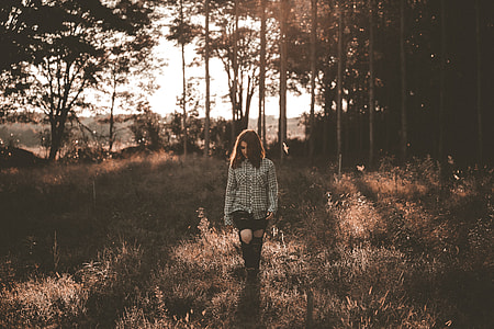 woman walking on grass field thumbnail