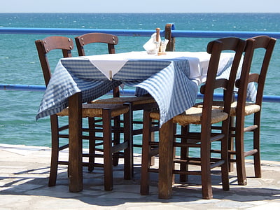 rectangular brown wooden table with blue checked table cloth with four chairs thumbnail