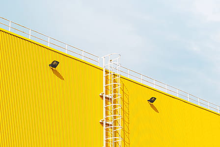 yellow metal building with white stair at daytime thumbnail