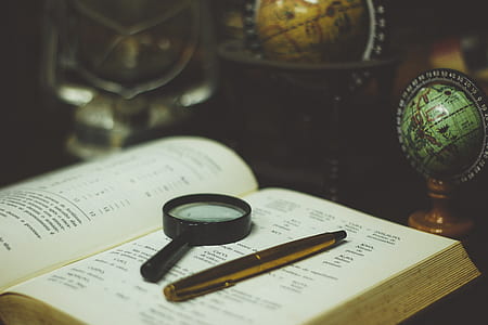 black magnifying glass on white book thumbnail