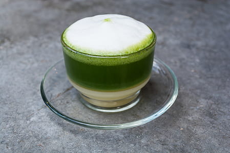 green liquid in clear glass drinking cup thumbnail