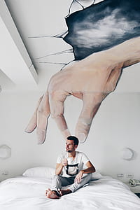 man wearing white and black T-shirt during daytime thumbnail