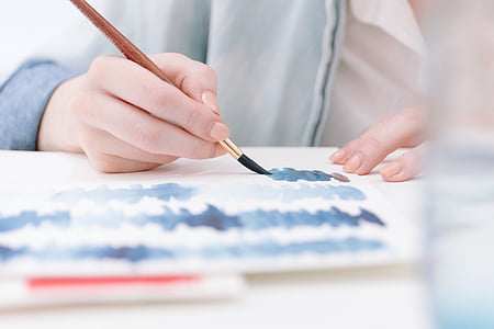 person holding brown paintbrush thumbnail