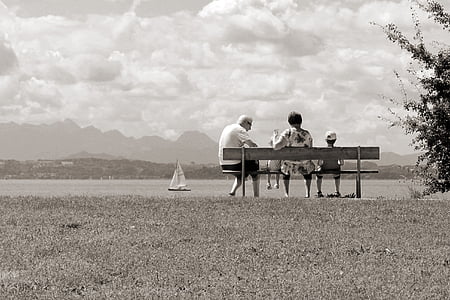 family sitting on bench infront of sea thumbnail