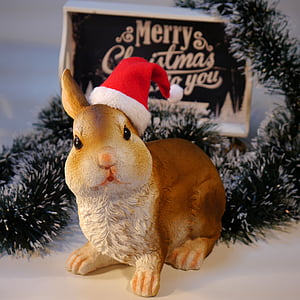 brown ceramic rabbit figurine wearing Santa hat thumbnail