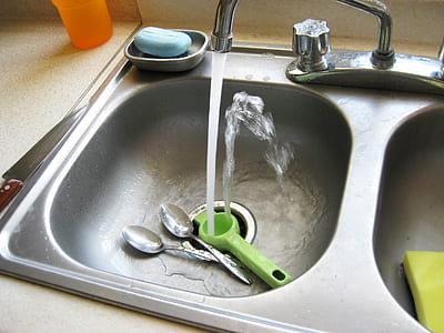grey stainless steel faucet turned on thumbnail
