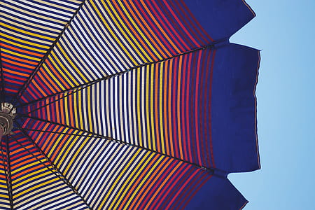 low angle view of multicolored patio umbrella thumbnail