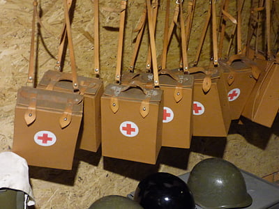 brown military medical sling bags hanged on wall thumbnail
