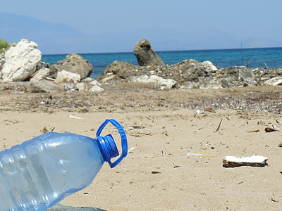 blue plastic gallon near body of water during daytime thumbnail
