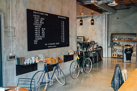 two green and blue bicycles beside wall rack inside building thumbnail