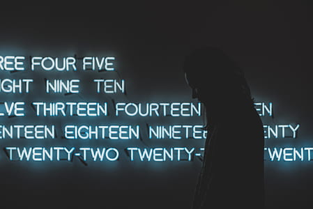 person standing in front of LED text signage thumbnail