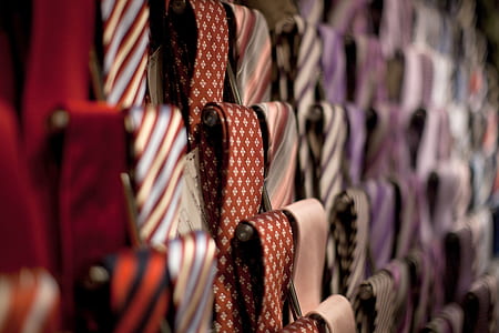 selective focus photography of assorted-color neckties on rack thumbnail