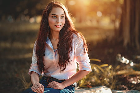 woman wearing white dress shirt sitting on bench thumbnail