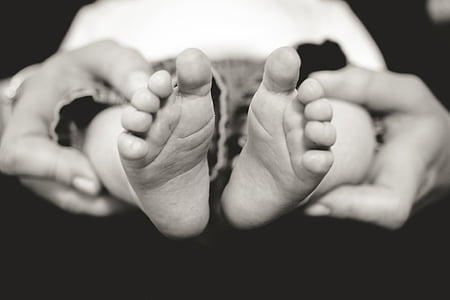 person holding toddler grayscale photo thumbnail