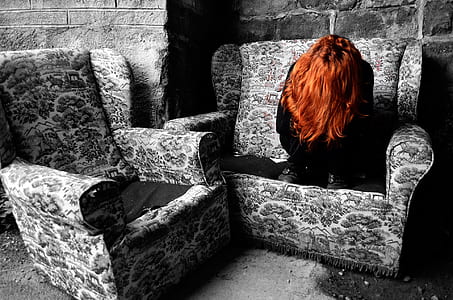 woman in black clothes and brown hair sitting on couch thumbnail