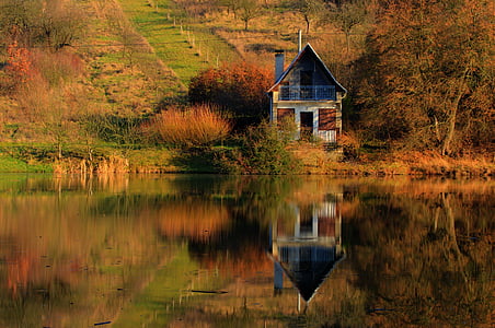 landscape photography of wooden structure near body of water thumbnail