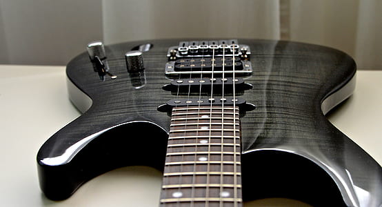 closeup photo of black and gray double cutaway electric guitar thumbnail