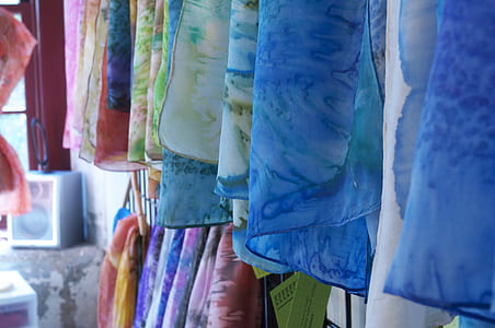 selective focus photography of assorted-color hanging clothes thumbnail