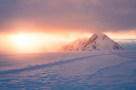 snow covered mountain during golden hour thumbnail