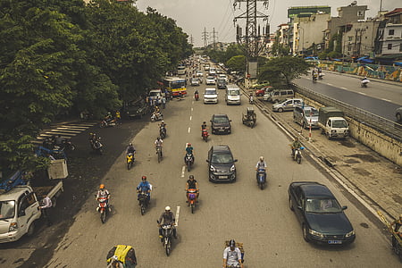 vehicles and motorcycles near green trees thumbnail