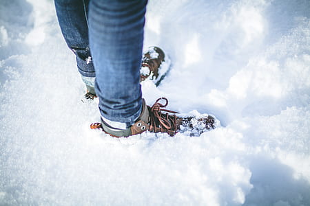 person on snow wearing shoes during daytime thumbnail