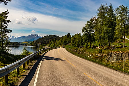 Brown Asphalt Road Beside Lake thumbnail