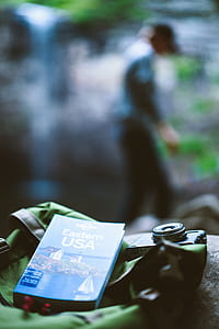 selective focus photography of Eastern USA book near camera on green bag thumbnail