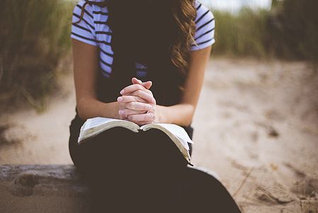 woman in black pants sitting and reading book thumbnail