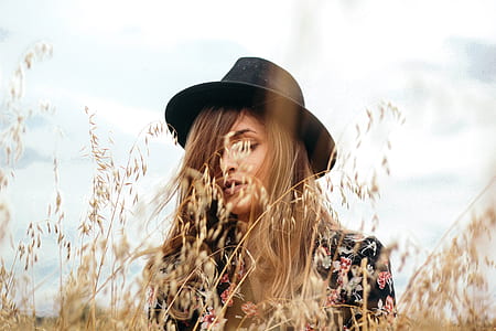 shallow focus photography of woman in brown and red floral top thumbnail