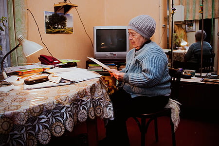 woman sitting on a chair while reading a letter thumbnail