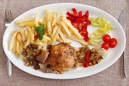 potato fries, fried chicken, and vegetables on white ceramic tray thumbnail