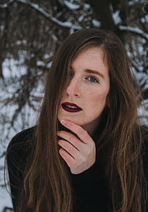 close-up photography of woman holding her chin thumbnail