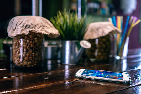 silver iPhone near clear glass jar thumbnail