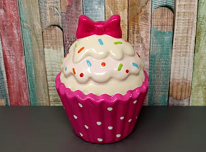 white and pink cupcake decor on top black surface thumbnail