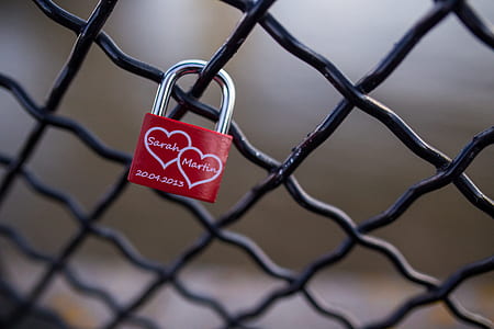 Red and Stainless Steel 2 Hearts Padlock on Black Cyclone Fence during Daytime thumbnail